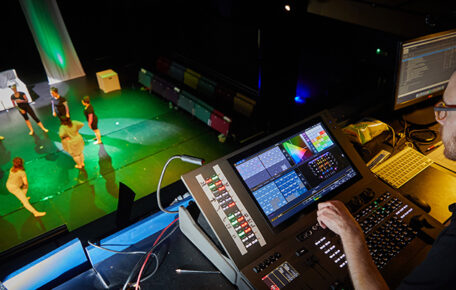 Technician working on a show taken so you can see them and performers on stage.