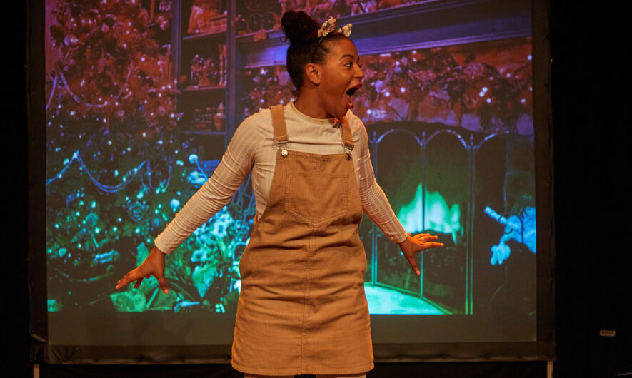 A performer looks to the right with their mouth open in excitement.