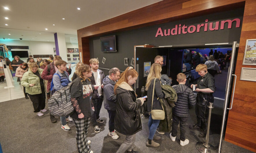 An audience walking into the Lincoln Arts Centre Auditorium
