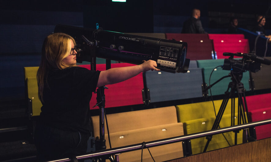 Person positioning a spotlight