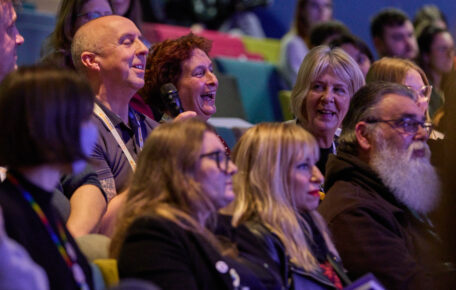 Audience members laugh in the Lincoln Arts Centre auditorium