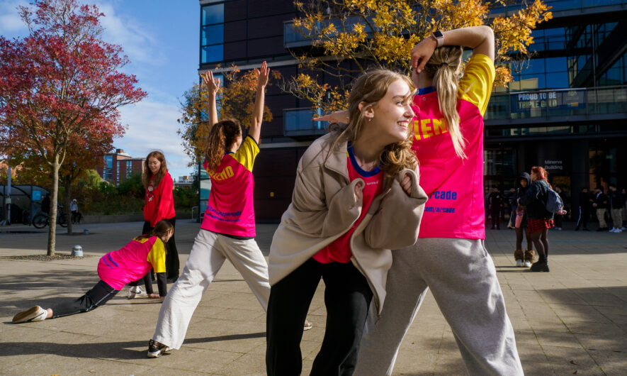 A group of dancers and participants outside dancing.