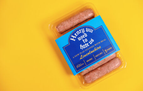 Henry VIII Used To Hate Us poster with lincolnshire sausages on a bright yellow background.