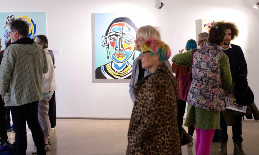 Picture of Tinashe Chipawe's artwork in a busy gallery space.