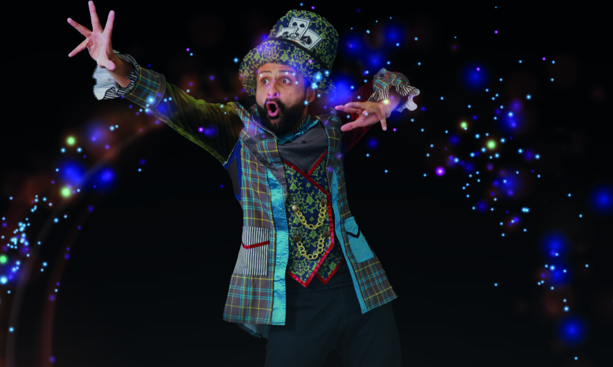 Promotional image for Meet the Hatter. The character wears a large top hat and long coat and interacts with a circle of light projected onto the stage.