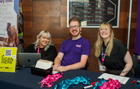 Three Lincoln Arts Centre staff members sat a table smiling.