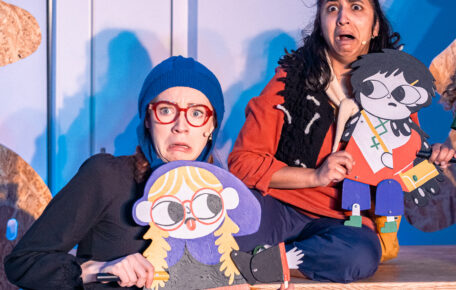 Two little vikings stand on stage looking scared.