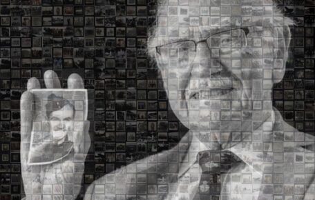 Mosaic style image of elderly man wearing glasses and a suit holding up a photograph of a younger man in a army uniform. Black and white image.