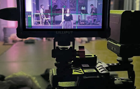 Behind the scenes shot of film camera recording.