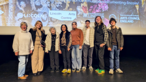 Film students and Women featured in Women On Film series on stage during Community film screening.